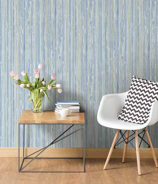 chair and table in front of wall with vertical striped wallpaper