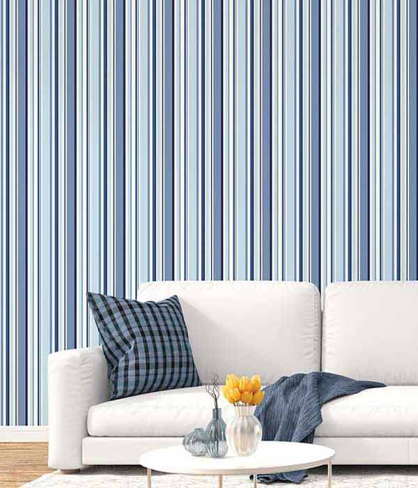 living room couch in front of a wall with blue vertical striped wall covering