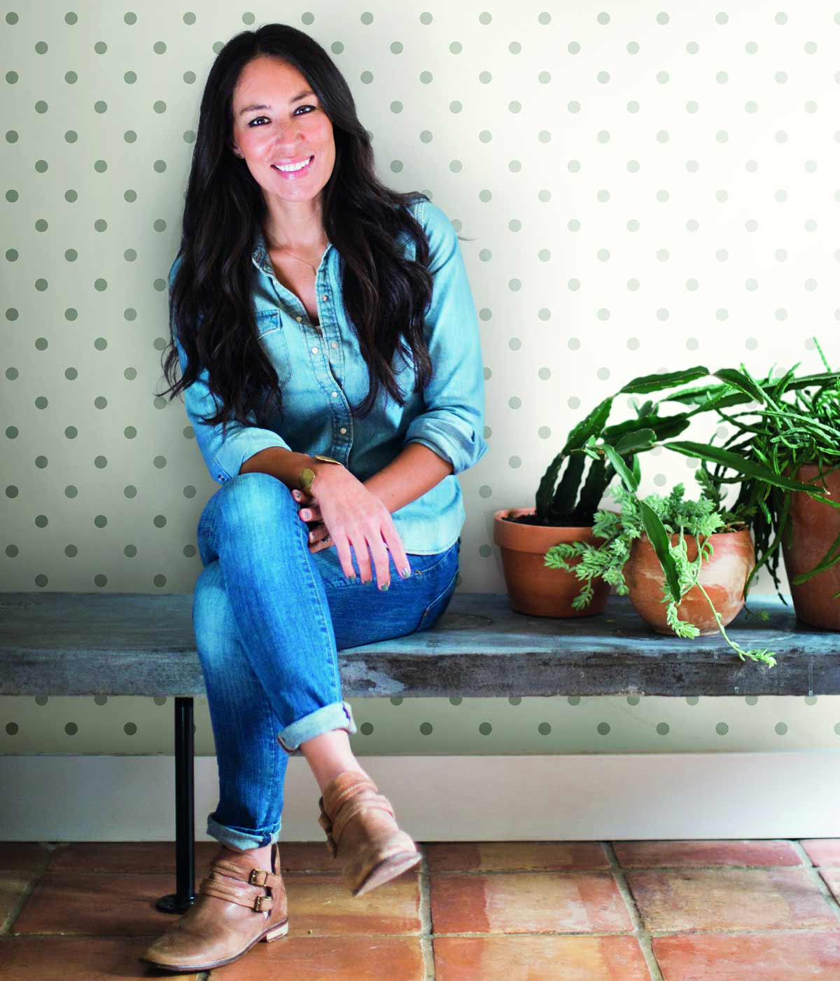 wallpaper designer Joanna Gaines in front of a wallpaper pattern by Magnolia Home