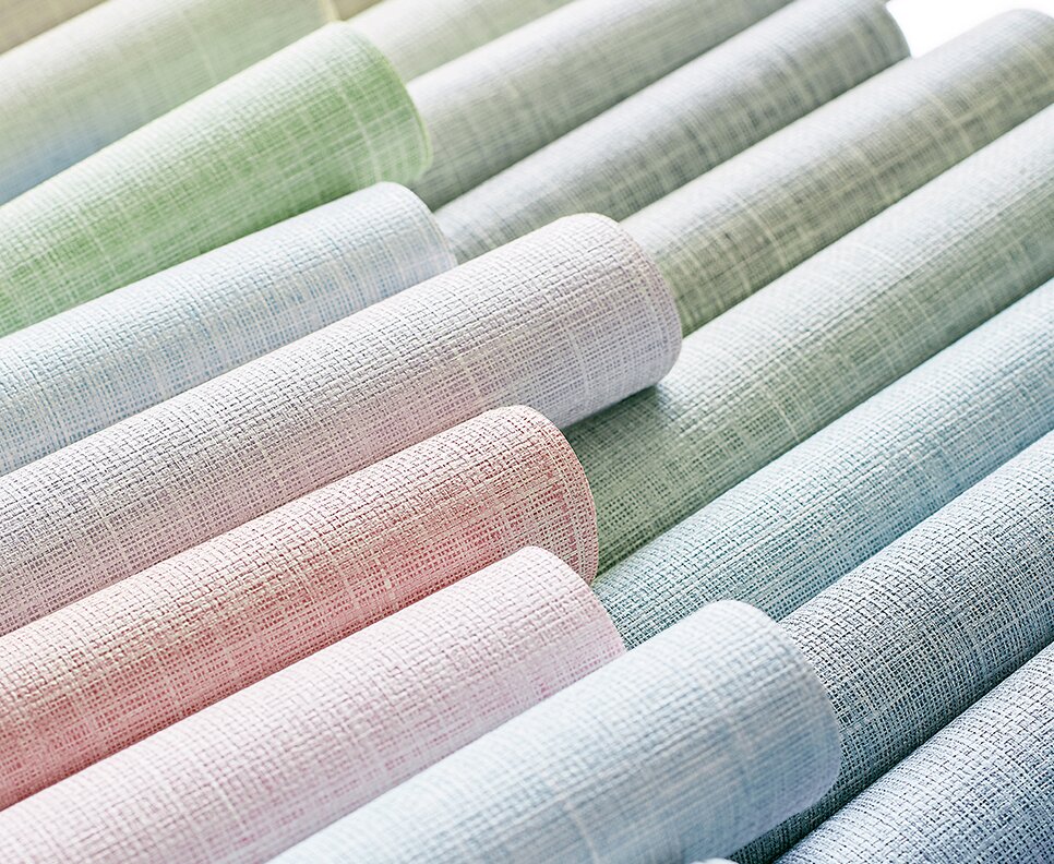 Rolls of textured wallpaper in pastel colors